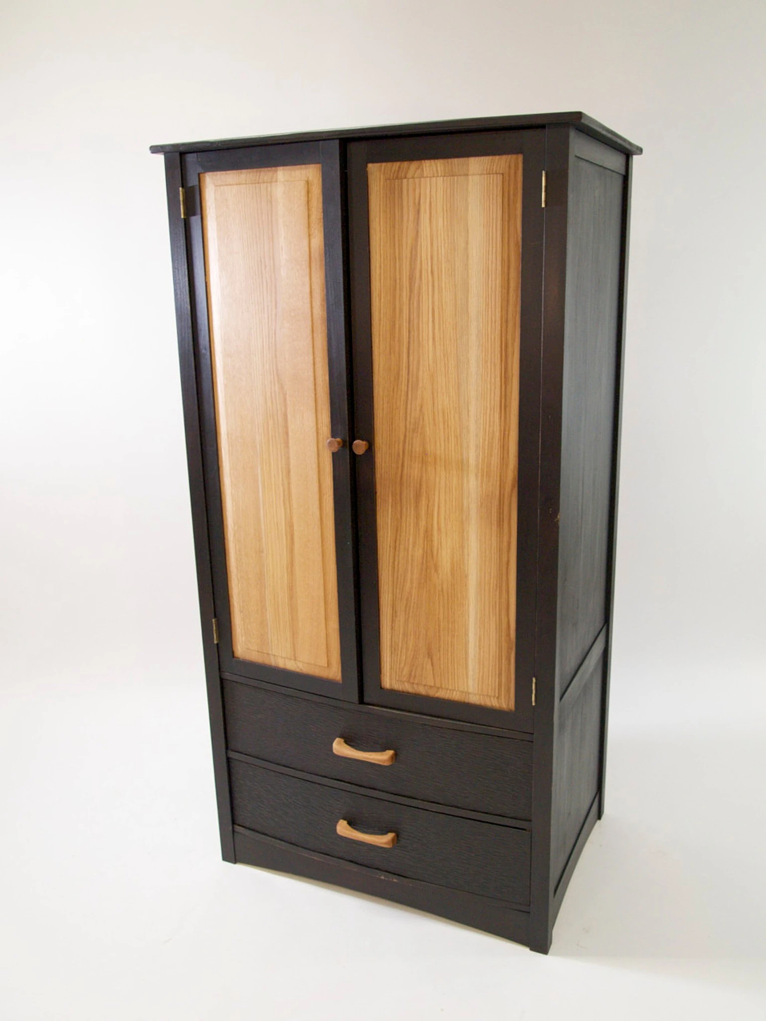 Tall black and natural grain wooden armoire